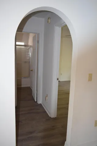 a bathroom with a granite countertop sink toilet and a mirror