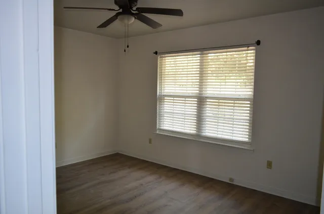 a front view of a house with a garden and yard