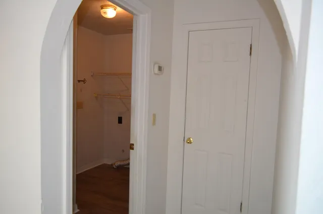 a view of an empty room with a fireplace and a window