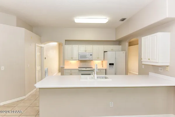 a kitchen with stainless steel appliances a sink and a refrigerator