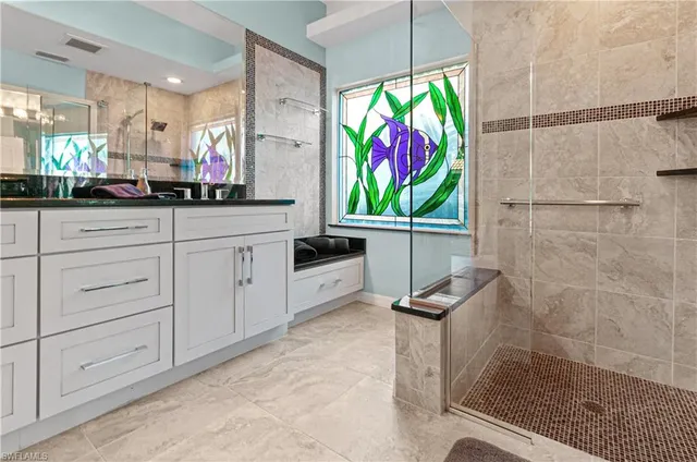 a kitchen with stainless steel appliances granite countertop a sink and a refrigerator