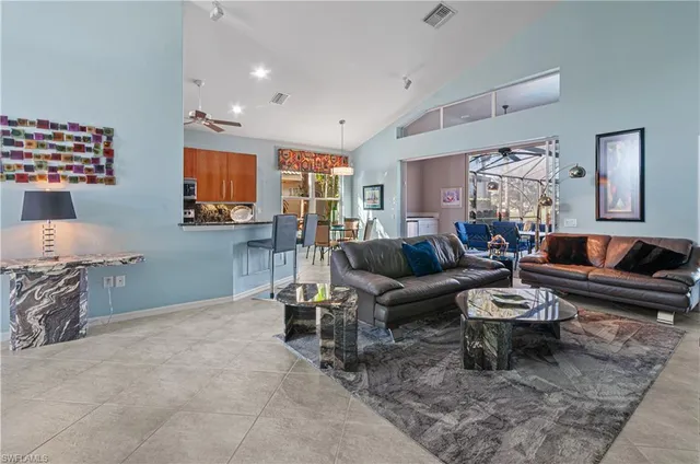 a living room with furniture a rug and a lamp