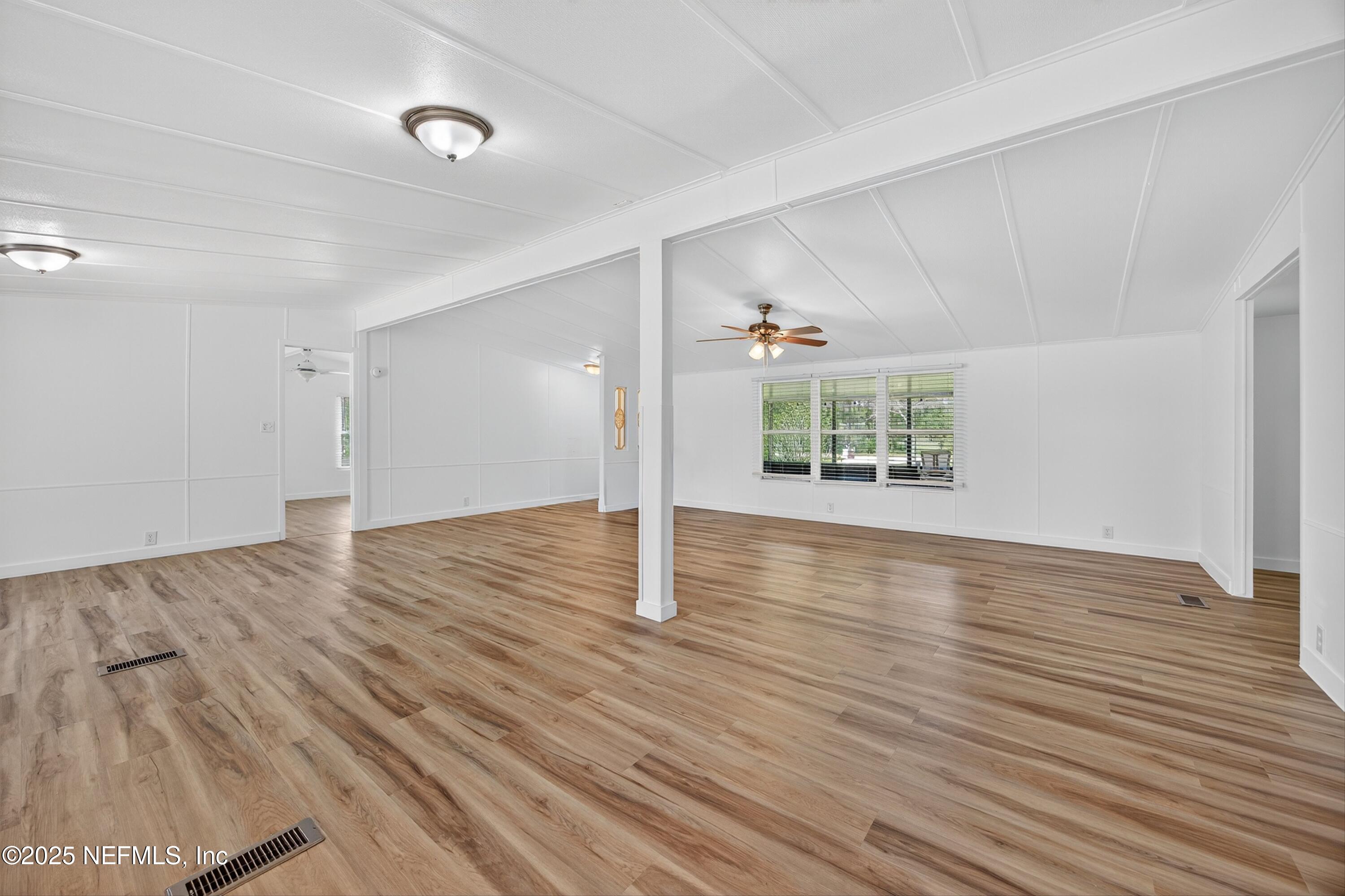 349 Stokes Landing Road St. Augustine, FL 32095 - Photo 11 of 45 wooden floor in an empty room with a window