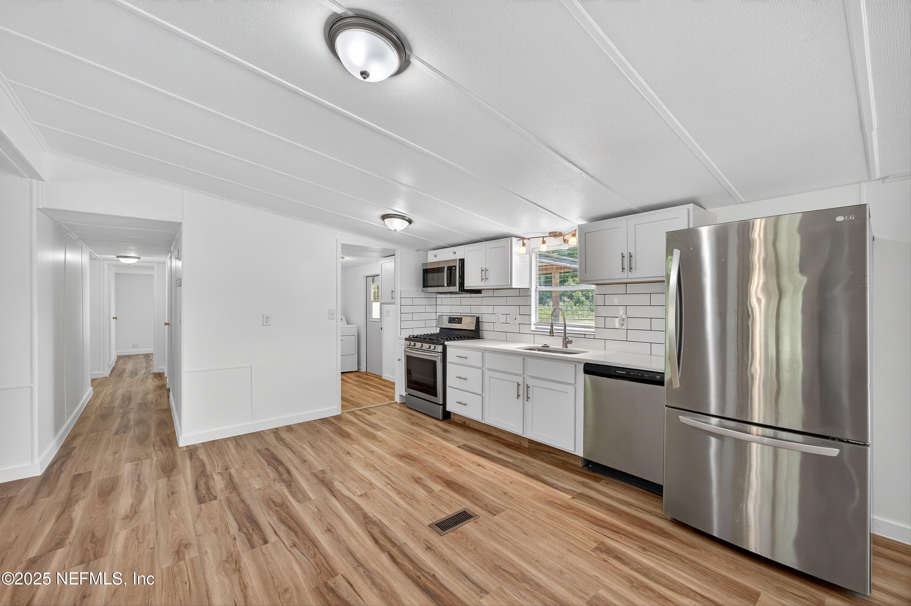 349 Stokes Landing Road St. Augustine, FL 32095 - Photo 17 of 45 a kitchen with stainless steel appliances a refrigerator sink and cabinets