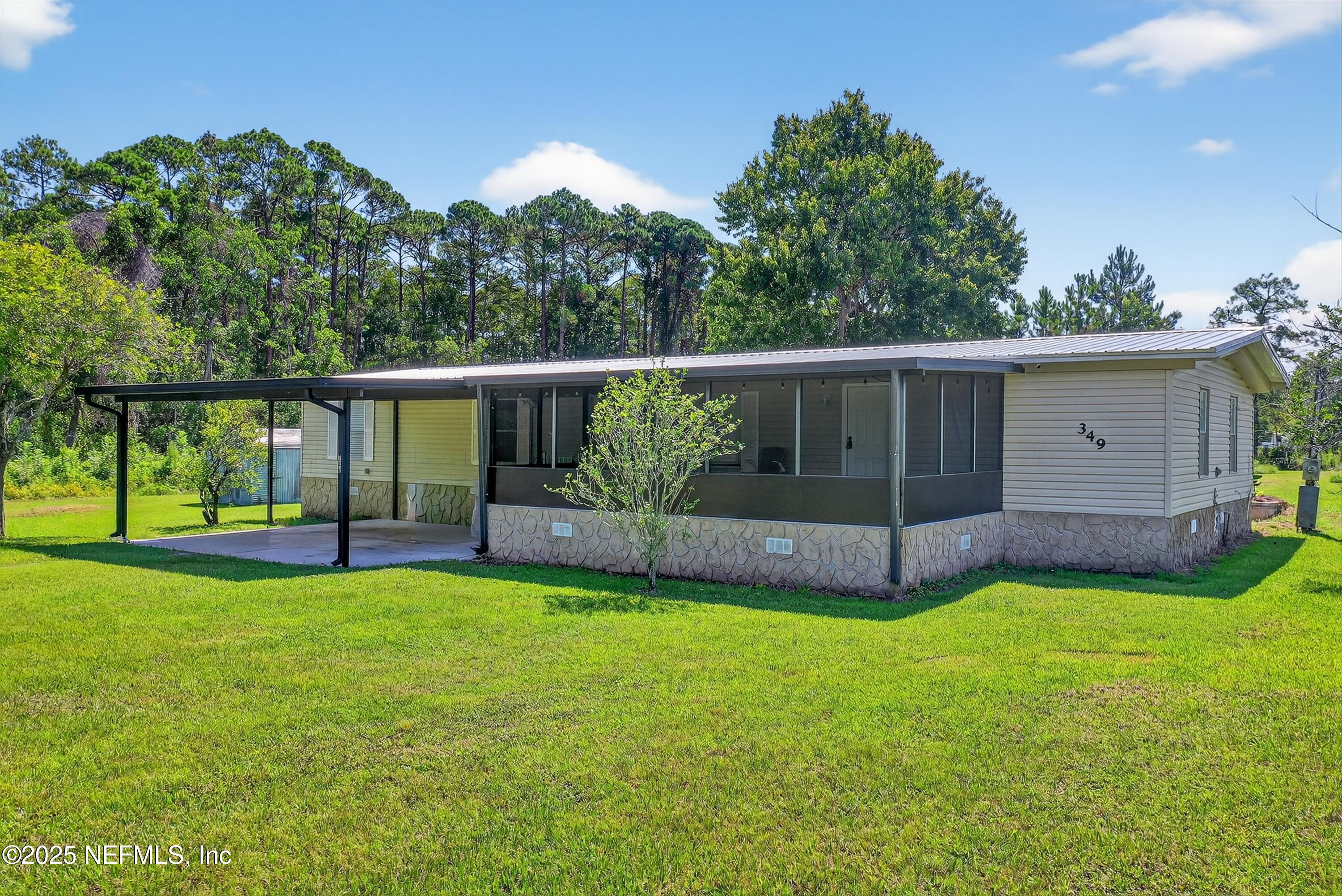 349 Stokes Landing Road St. Augustine, FL 32095 - Photo 2 of 45 a view of a backyard with a garden and plants