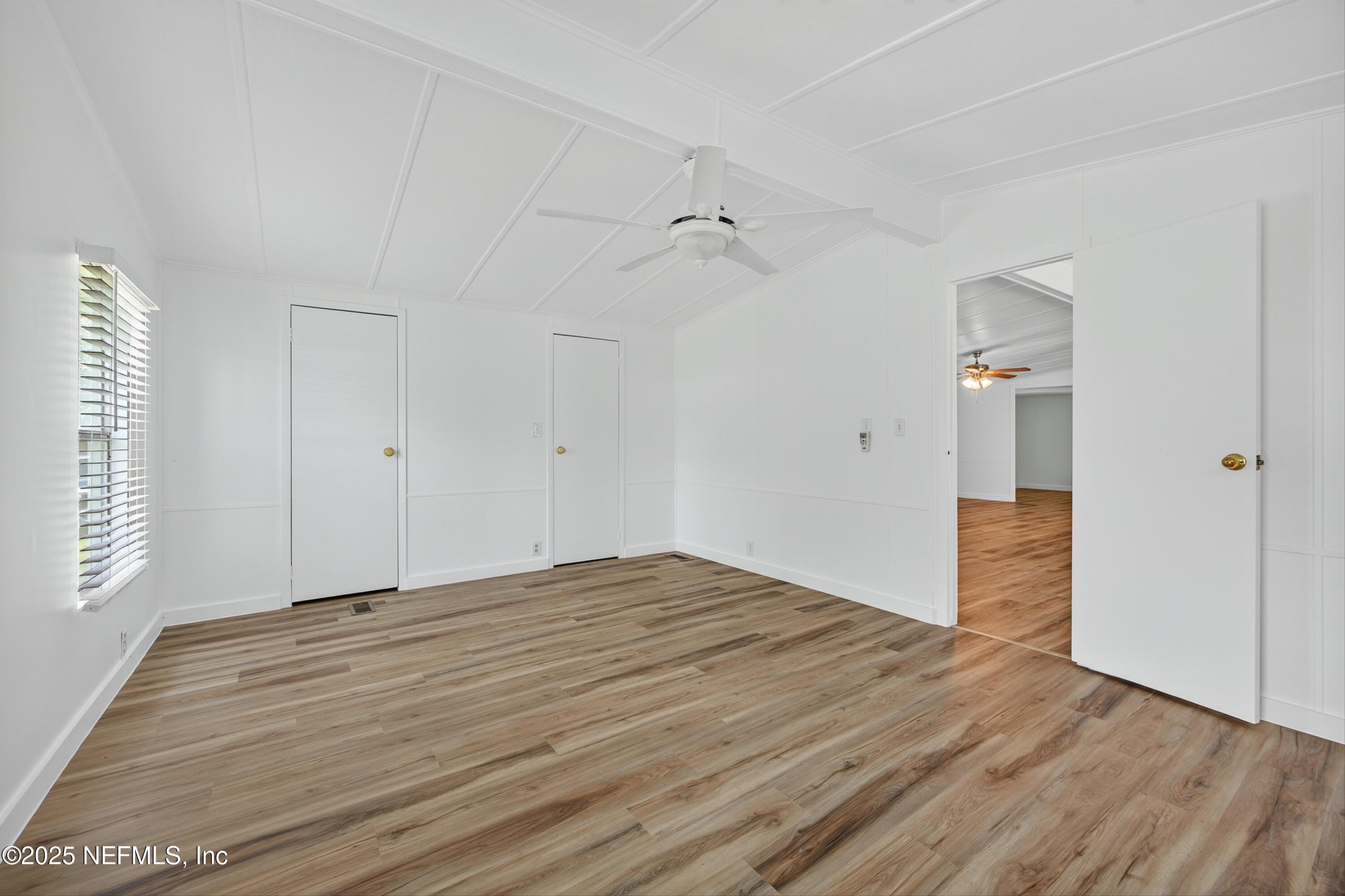 349 Stokes Landing Road St. Augustine, FL 32095 - Photo 23 of 45 wooden floor in an empty room with a window