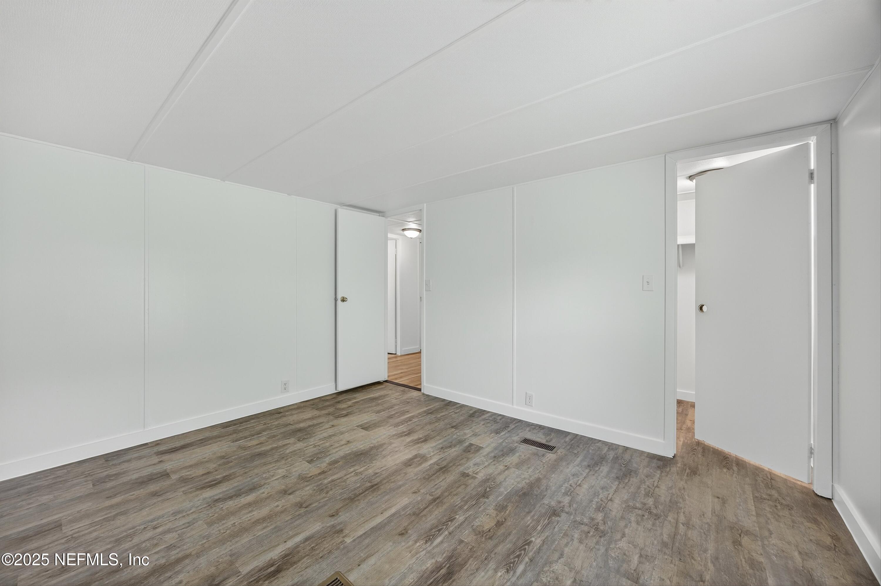 349 Stokes Landing Road St. Augustine, FL 32095 - Photo 27 of 45 a view of an empty room with wooden floor