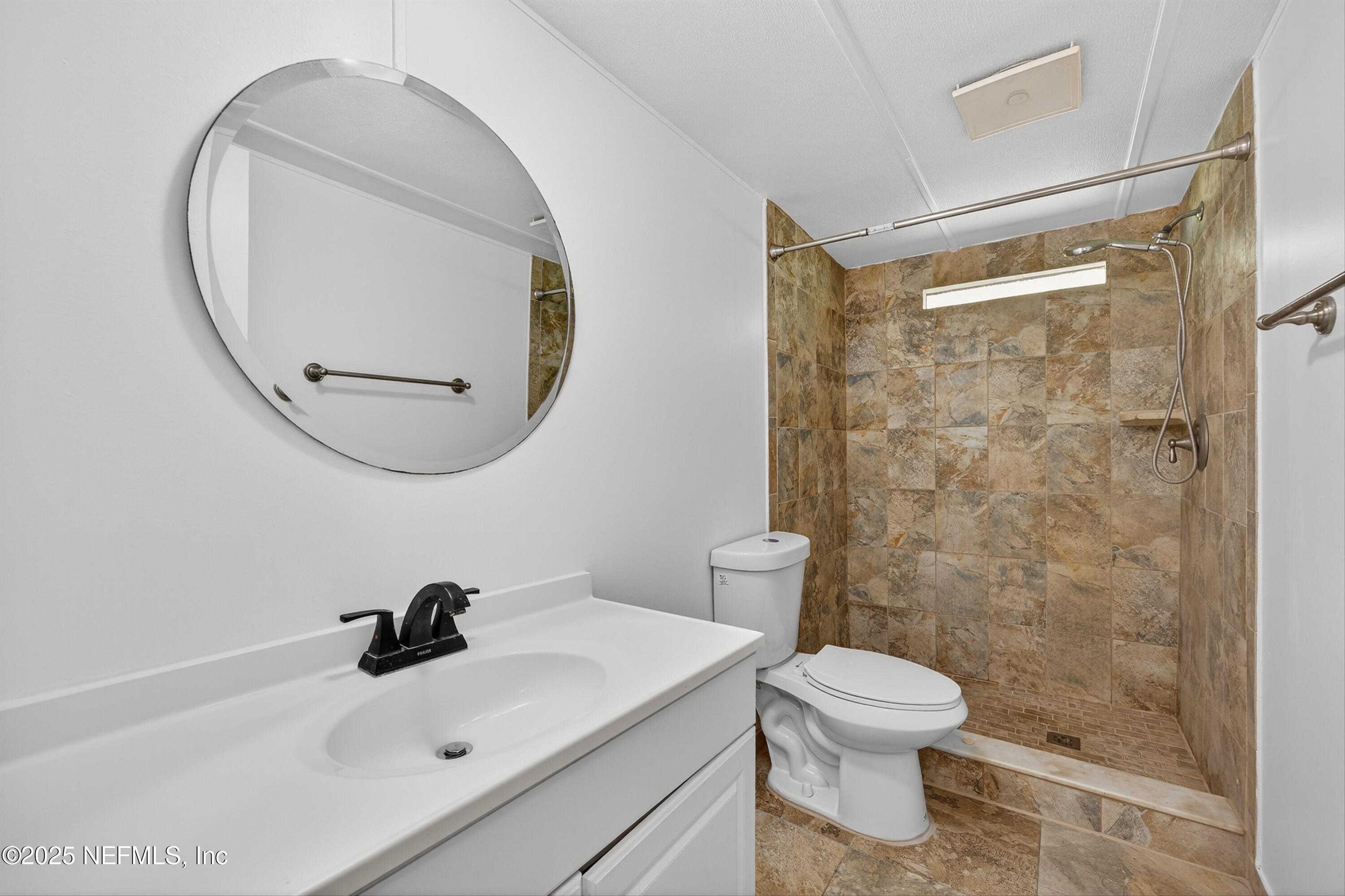 349 Stokes Landing Road St. Augustine, FL 32095 - Photo 28 of 45 a bathroom with a sink a toilet and a mirror