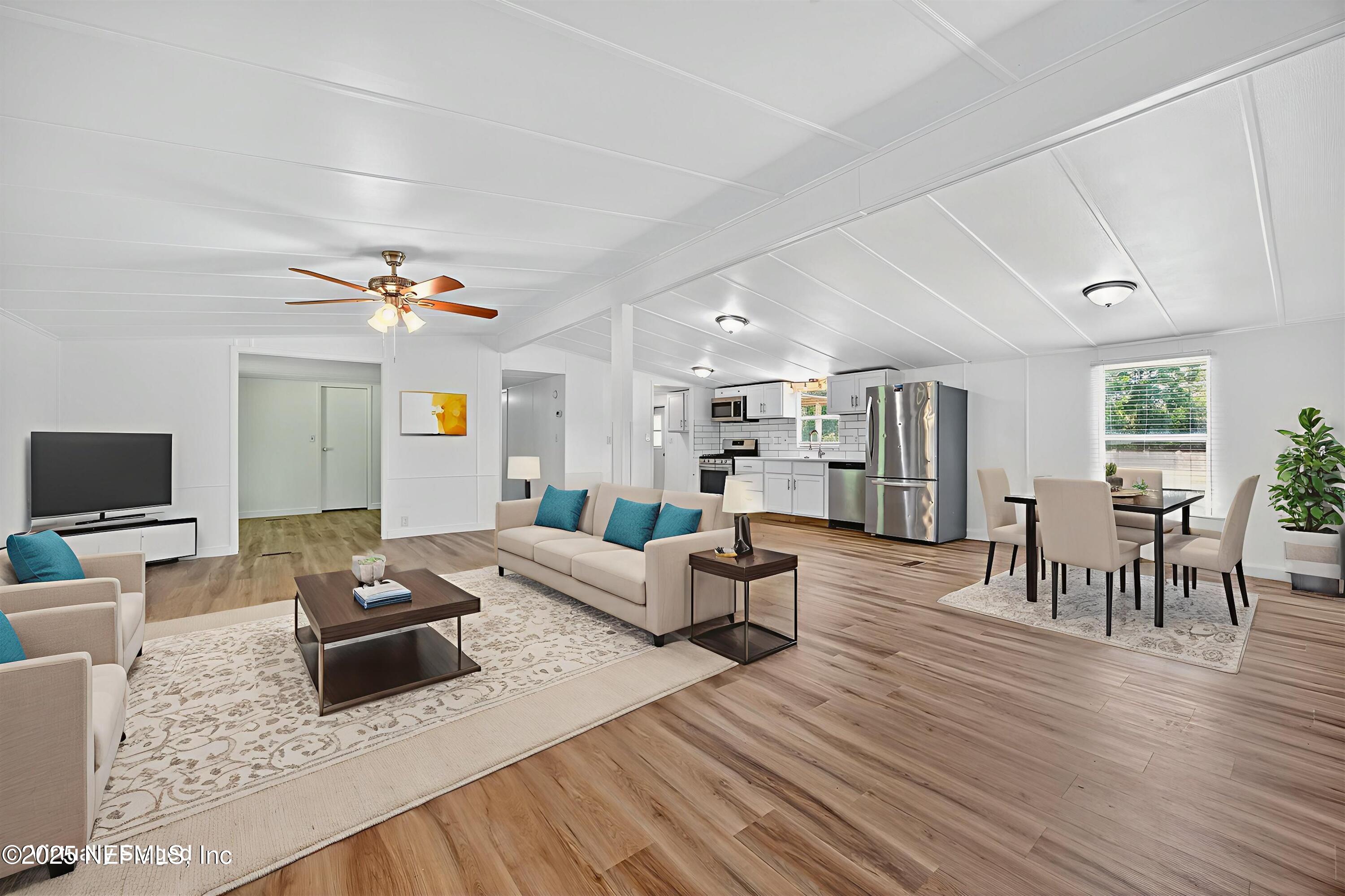 349 Stokes Landing Road St. Augustine, FL 32095 - Photo 8 of 45 a living room with furniture and a flat screen tv