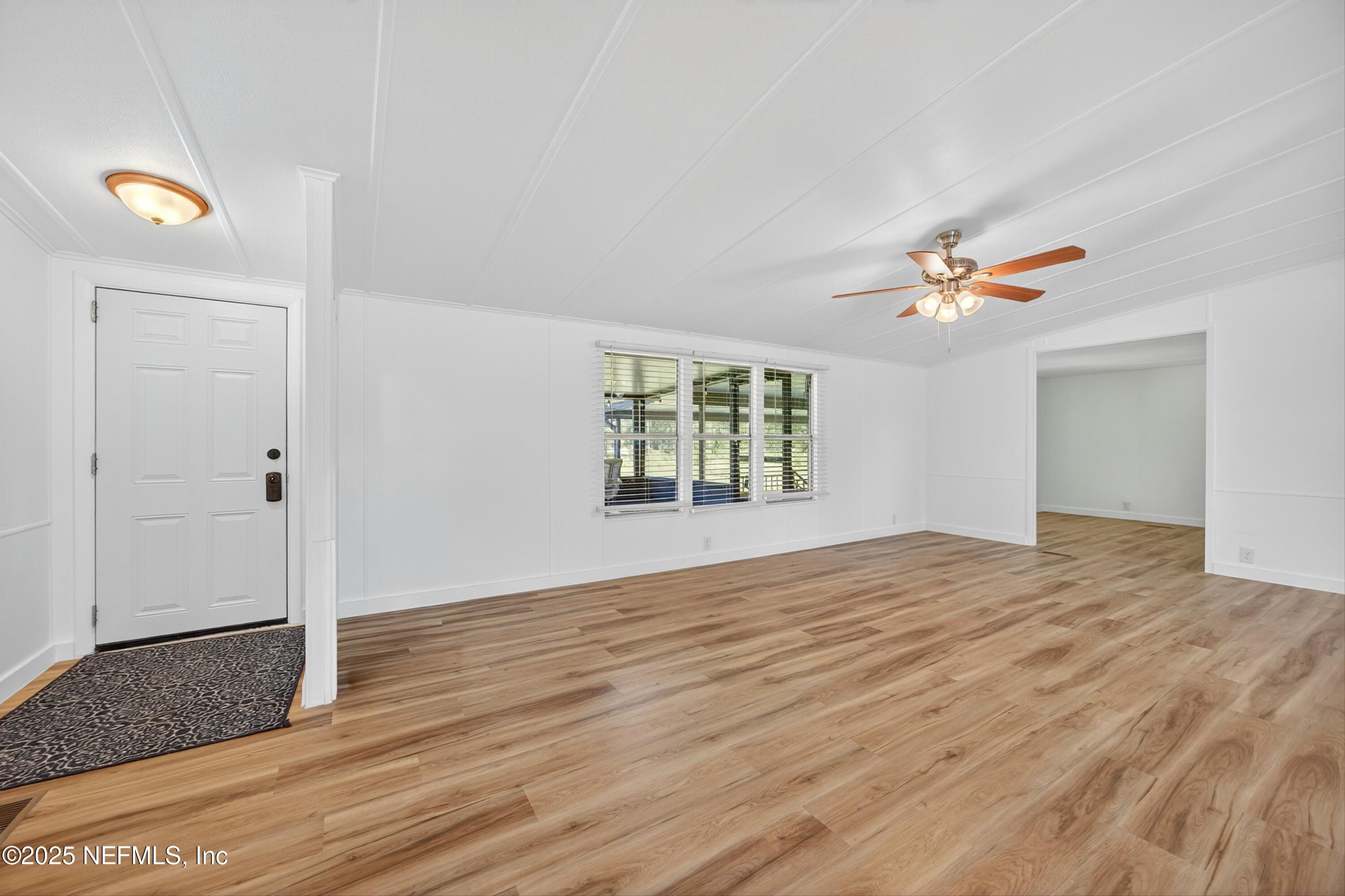 349 Stokes Landing Road St. Augustine, FL 32095 - Photo 10 of 45 wooden floor in an empty room with a window