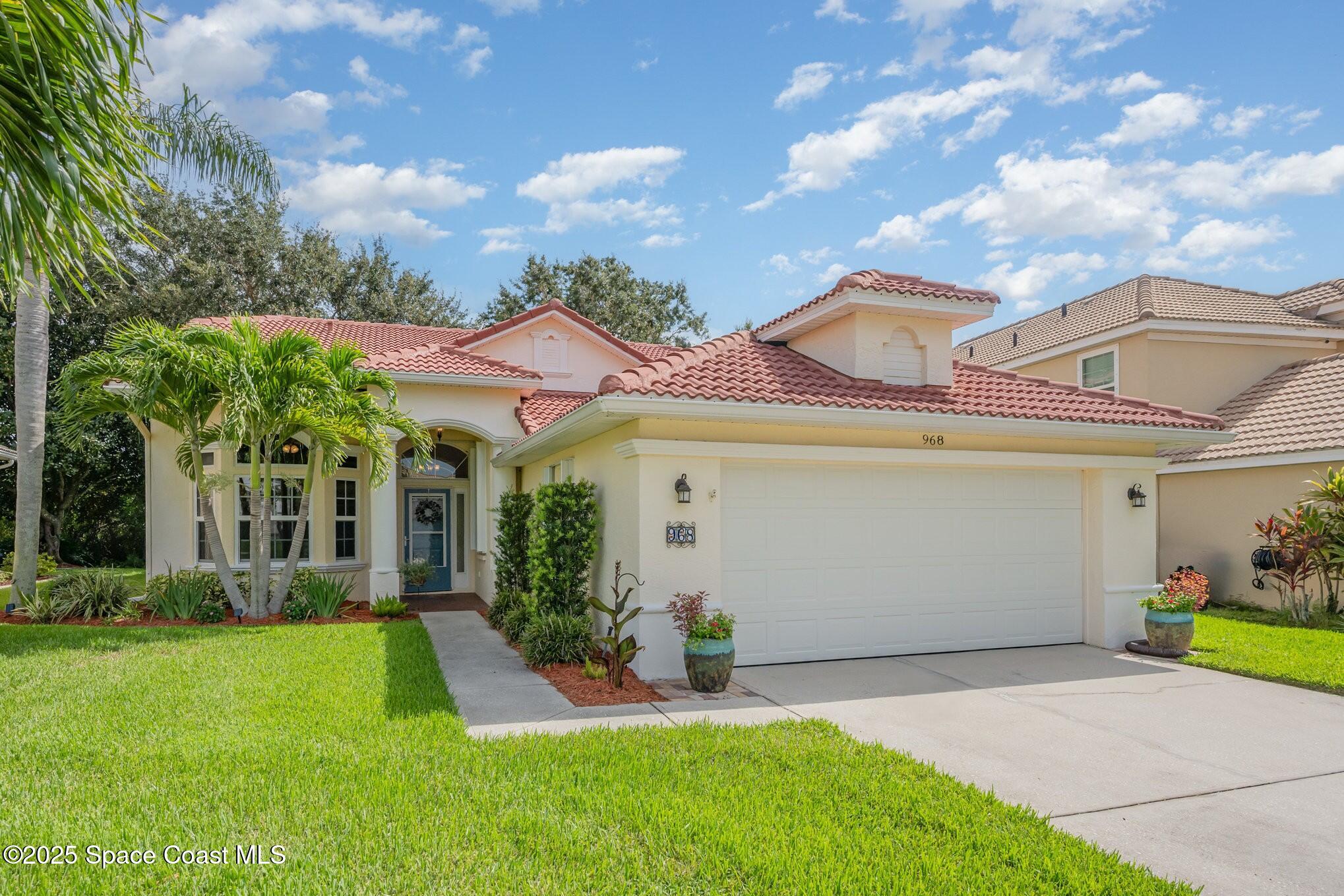 968 Wimbledon Drive Melbourne, FL 32940 - Photo 6 of 47 a view of a white house with a big yard plants and large trees