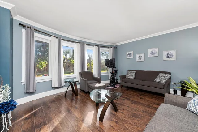 a living room with furniture and floor to ceiling windows