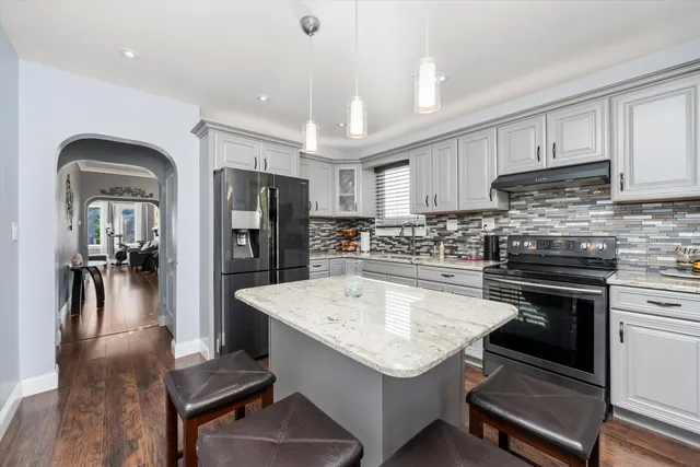 a kitchen with a refrigerator a sink and cabinets