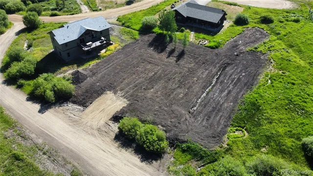 an aerial view of a house with a yard and garden