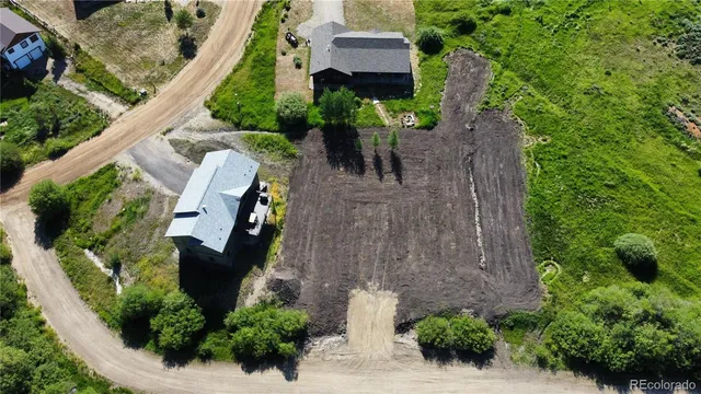 an aerial view of a house with a yard and plants