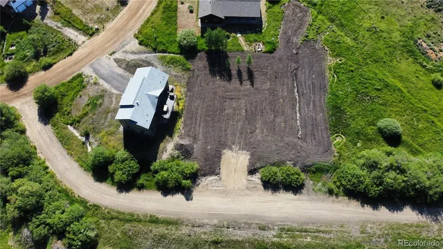 an aerial view of a house with a yard and potted plants