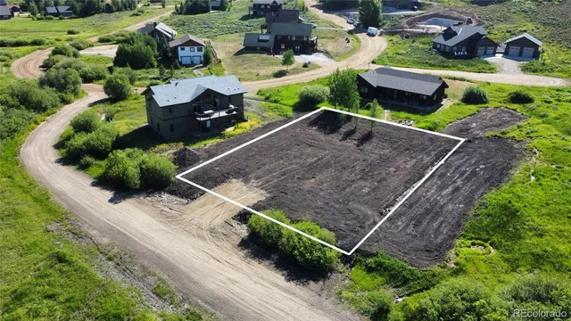 an aerial view of a house with a yard and potted plants