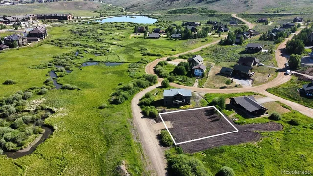an aerial view of residential house with outdoor space and parking