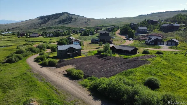 a view of a lush green hillside and houses