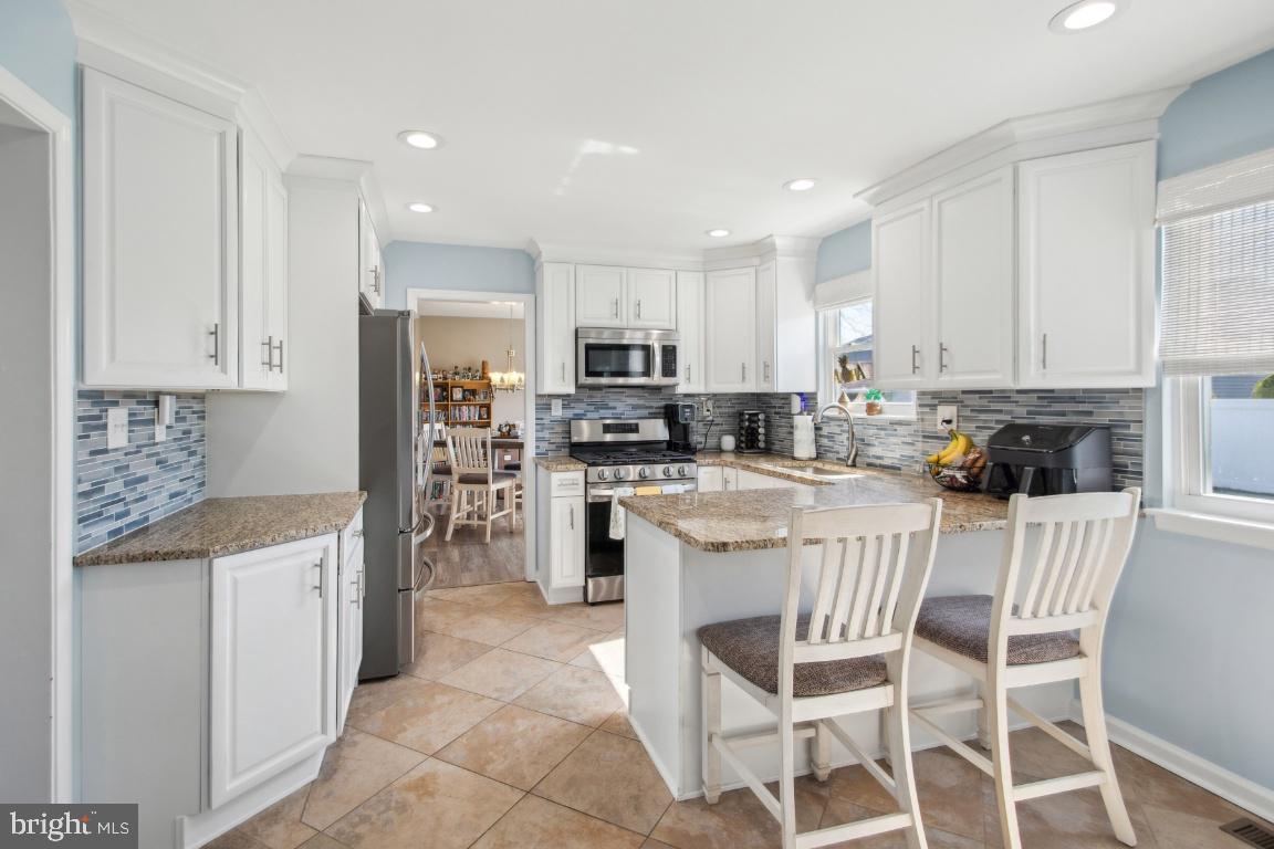 9 Midwood Road Marlton, NJ 08053 - Photo 9 of 26 a kitchen with stainless steel appliances granite countertop a stove top oven a refrigerator a sink and a microwave