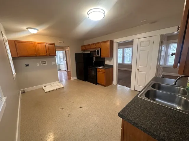 a kitchen with a sink stove and refrigerator