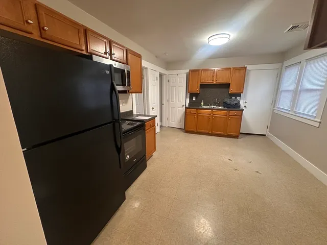 a kitchen with stainless steel appliances a refrigerator and a stove