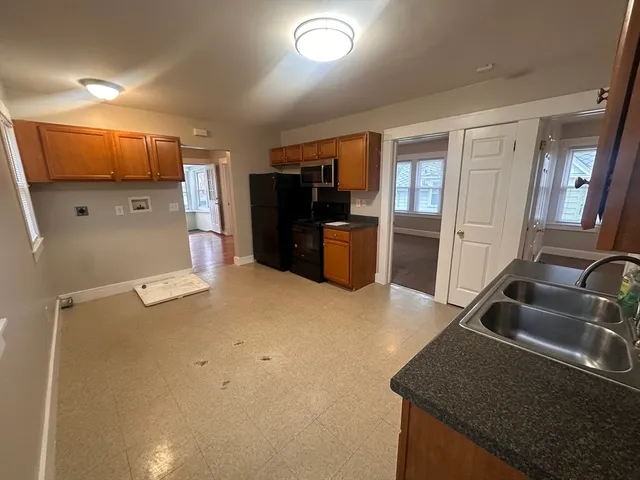 a kitchen with refrigerator and sink