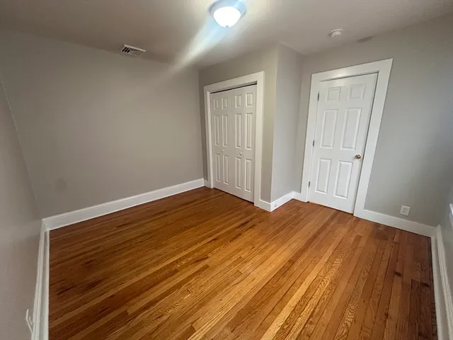 a view of a room with wooden floor and windows