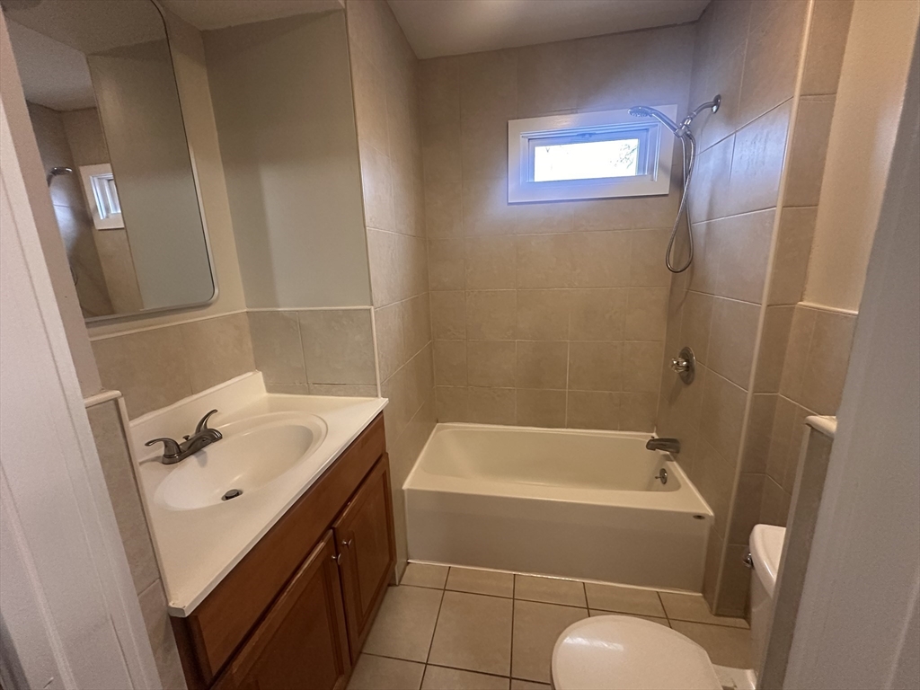 383 Newbury Street, Unit 2 Springfield, MA 01104 - Photo 8 of 11 a bathroom with a sink a toilet and shower