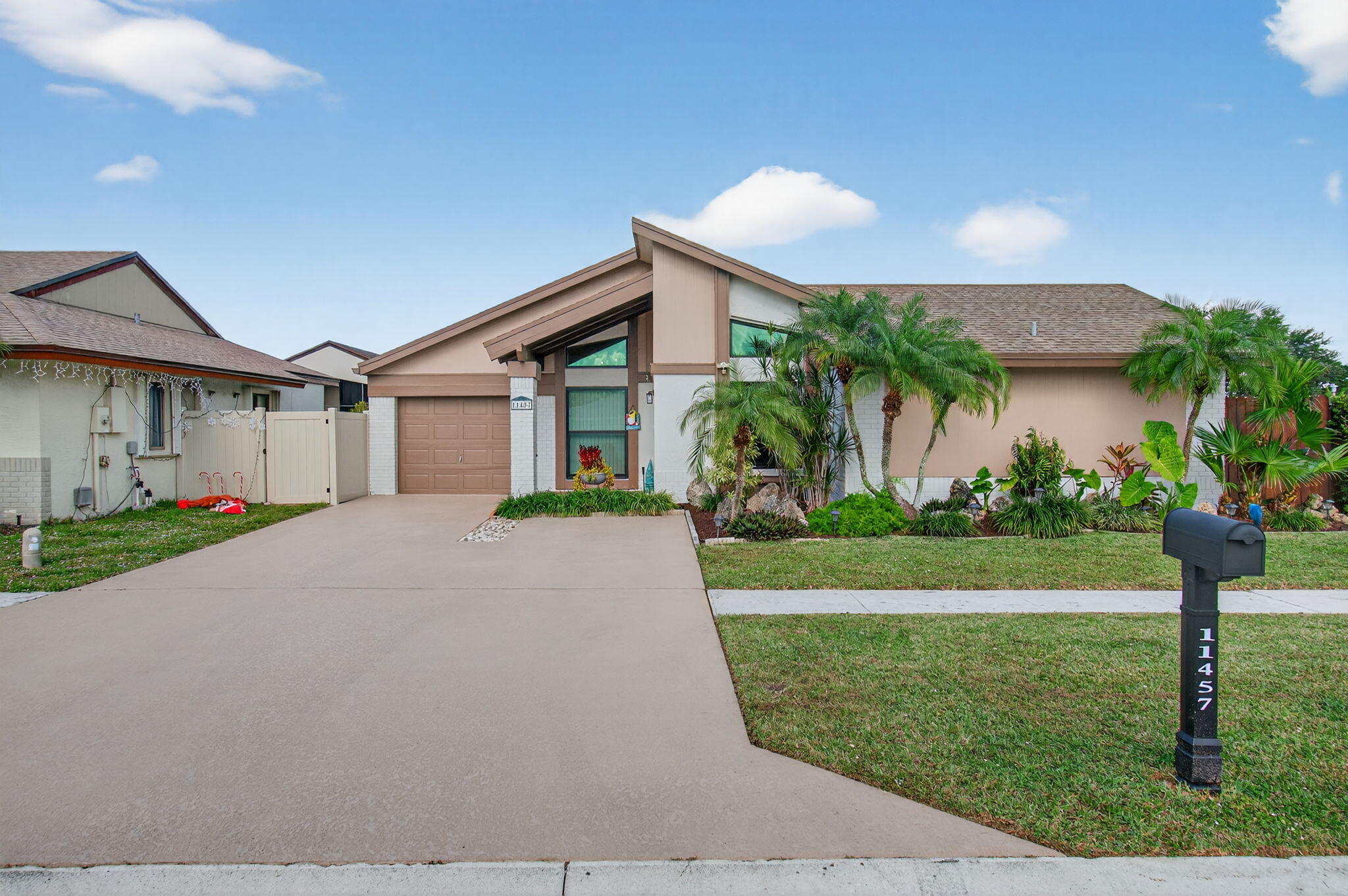 11457 Country Sound Court Boca Raton, FL 33428 - Photo 2 of 112 a front view of a house with garden