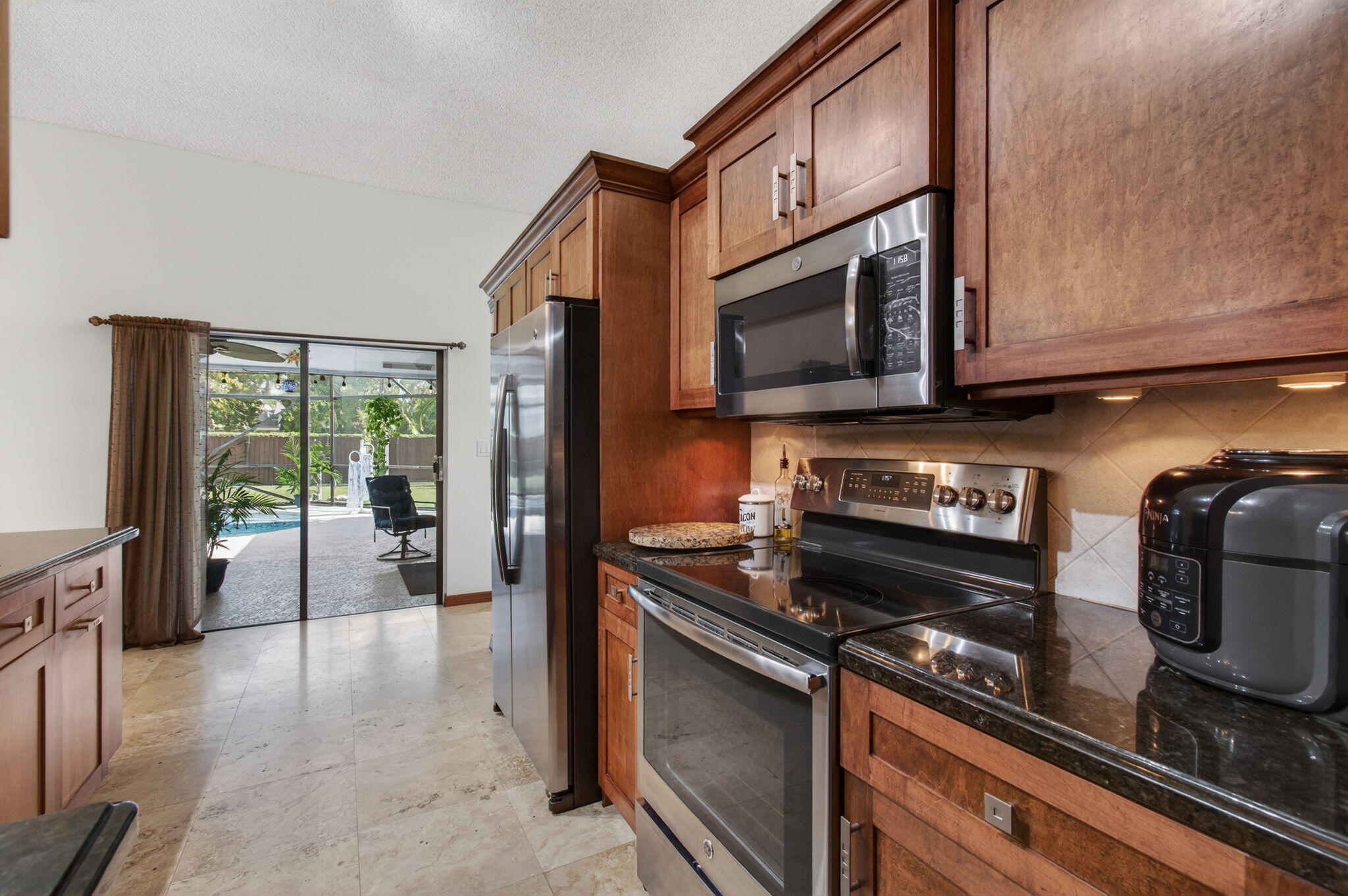 11457 Country Sound Court Boca Raton, FL 33428 - Photo 32 of 112 a kitchen with stainless steel appliances granite countertop a stove and a microwave