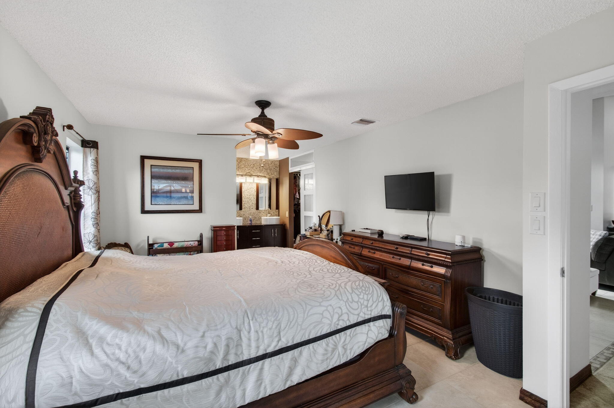11457 Country Sound Court Boca Raton, FL 33428 - Photo 50 of 112 a bedroom with a bed and a flat screen tv