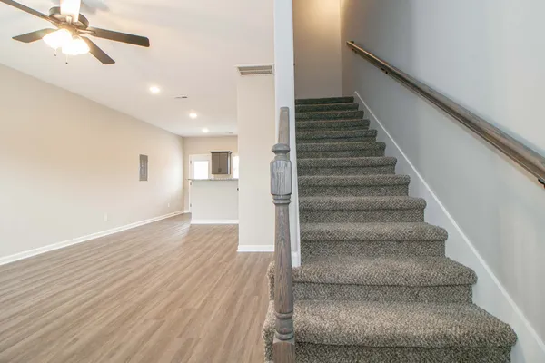 a view of entryway and hall with wooden floor