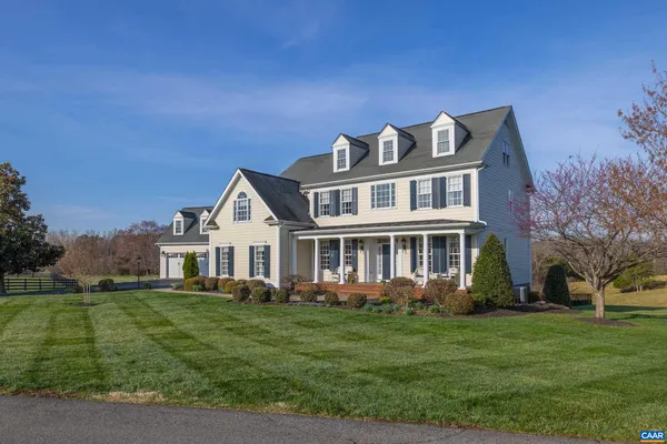 a front view of a house with a garden and plants