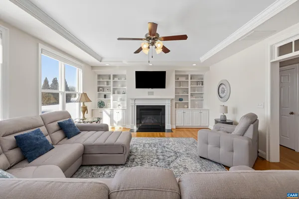 a kitchen with stainless steel appliances granite countertop a stove a sink a microwave a dining table and chairs with wooden floor