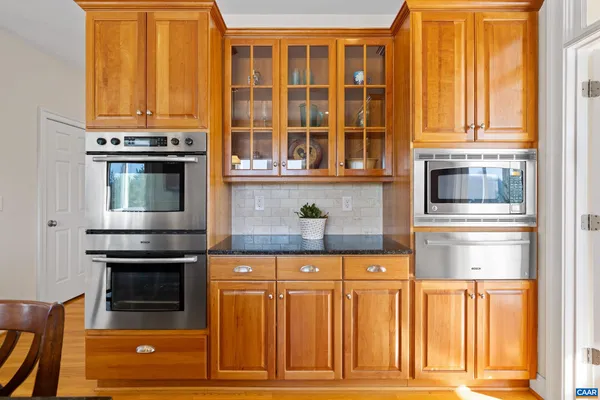 a bedroom with a bed lamps and wooden floor