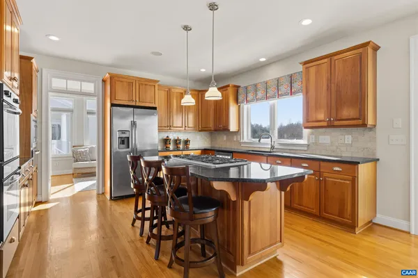 a large white bathroom with a granite countertop sink mirror and a bathtub