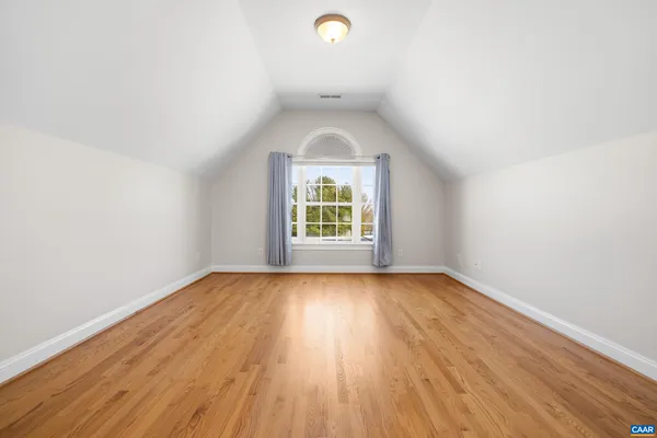 a spacious bedroom with a bed and glass door