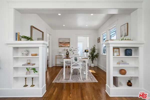 a view of living room with furniture and wooden floor