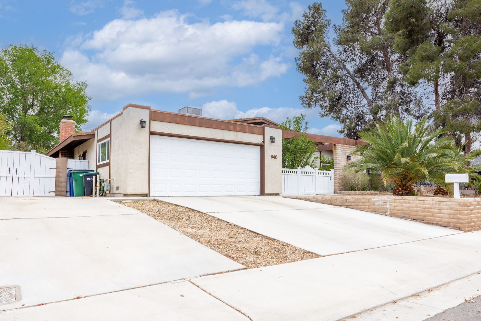 640 Peg Street Ridgecrest, CA 93555 - Photo 2 of 25 a front view of a house with a garage