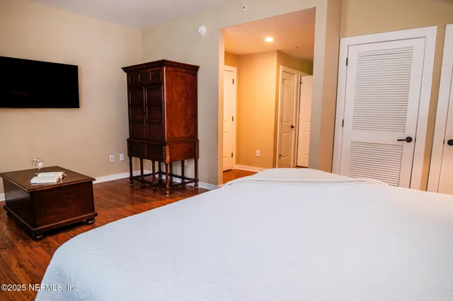 a bedroom with a bed and a flat screen tv