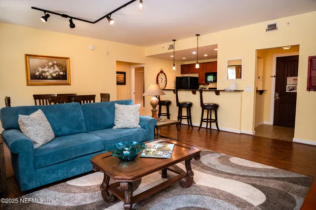 a living room with furniture and wooden floor