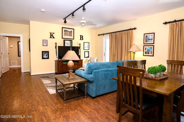 a living room with furniture and wooden floor