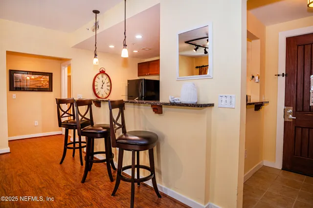 a view of a room with breakfast area and wooden floor