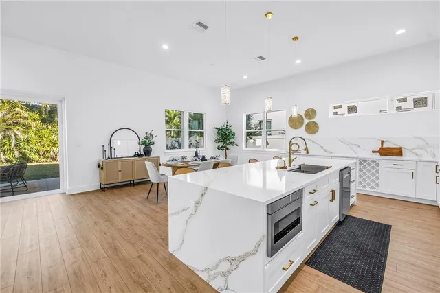 a kitchen with a sink appliances and a counter top space