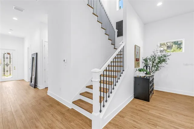a view of entryway with wooden floor and stairs