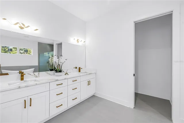 a bathroom with a double vanity sink and a mirror