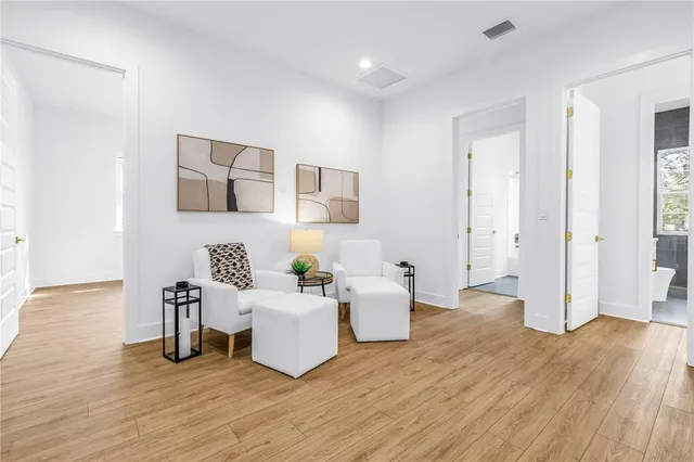 a living room with furniture and wooden floor