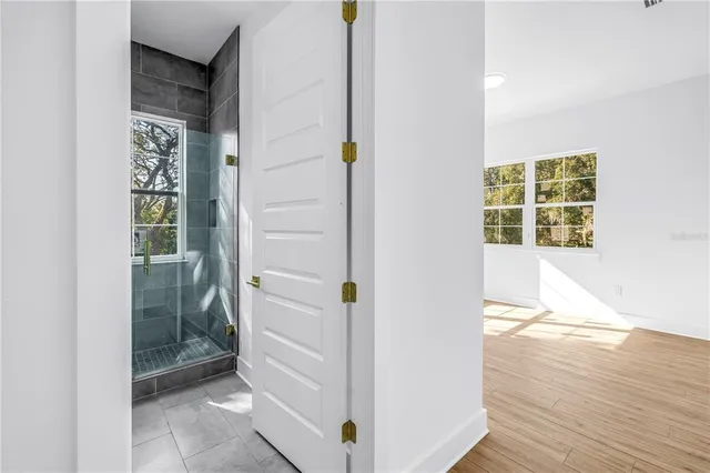 hallway with wooden floor and windows