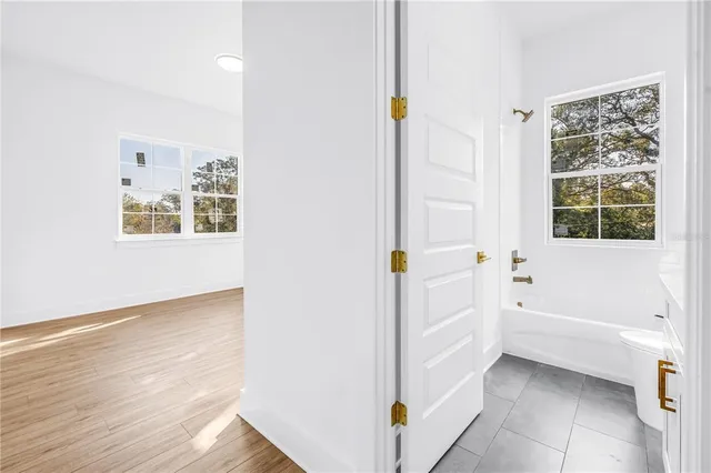 a bathroom with a bathtub and a window